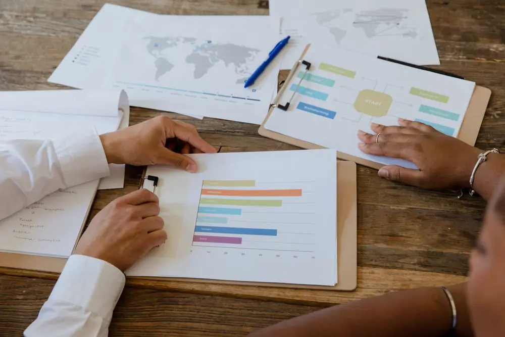 Colleagues reviewing charts on a table